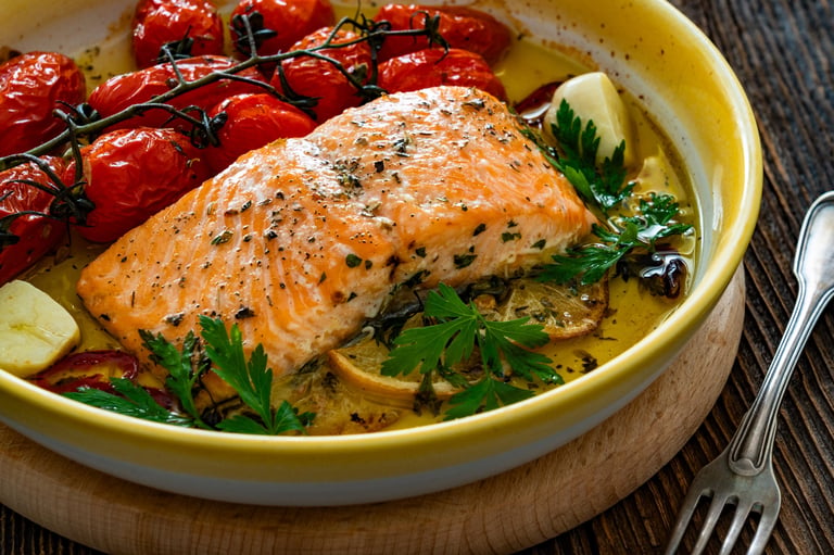 Roasted salmon steak with cherry tomatoes on wooden table