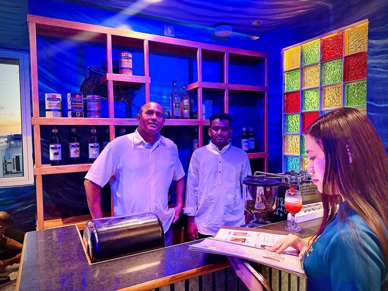 Two men and a woman in a modern retail store with neon pink shelving, colorful grid backdrop, and blue ambient lighting