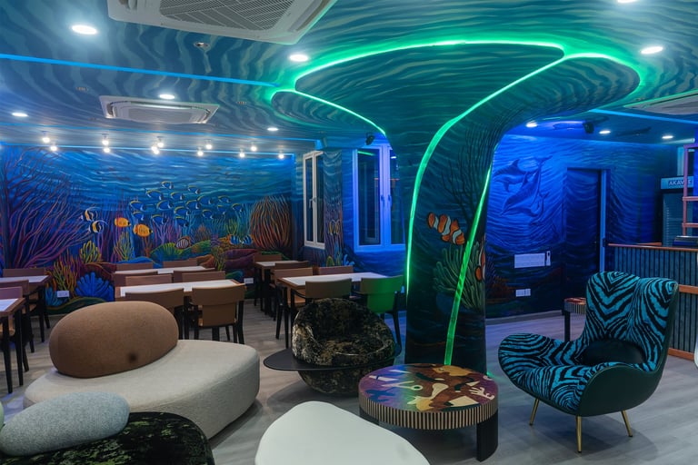 Modern lounge with neon green and blue lighting, underwater mural, curved seating, zebra-print chair, and ambient sculptural lighting installations