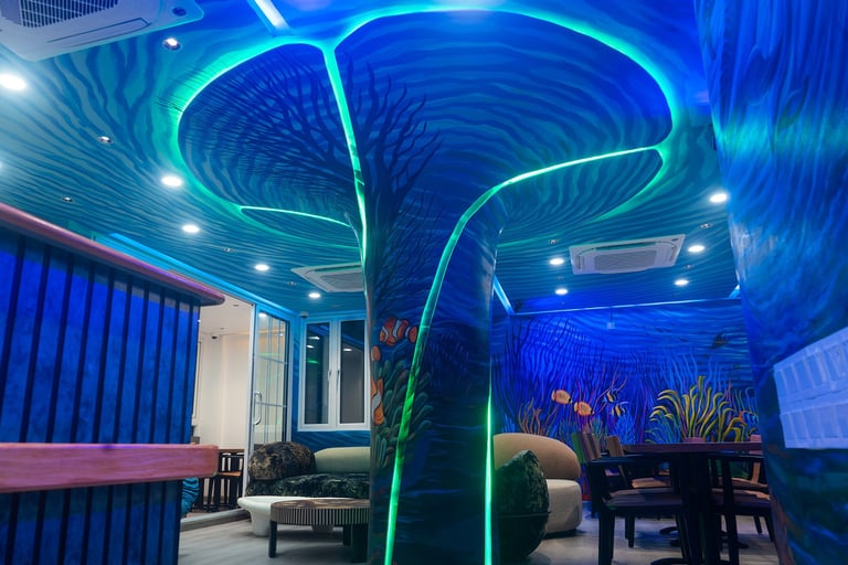 Modern interior with glowing blue neon lights outlining curved ceiling design and decorative elements in contemporary lounge space