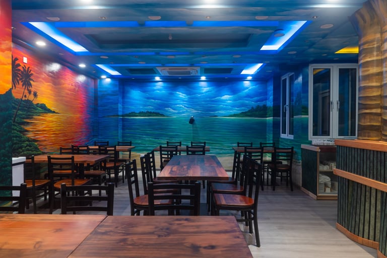 Modern restaurant interior with blue neon ceiling lighting, wooden dining tables and chairs, ocean mural backdrop, and warm ambient lighting